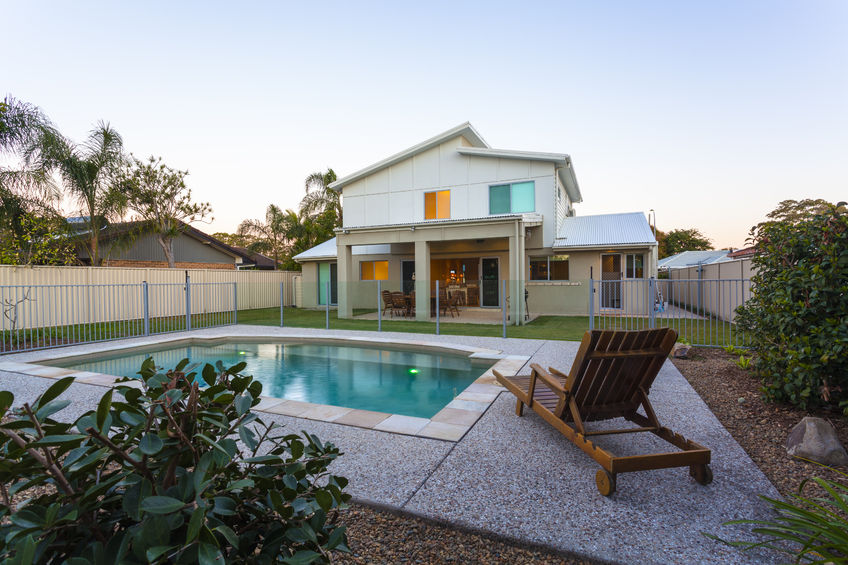 36454966 – modern home exterior with pool at dusk